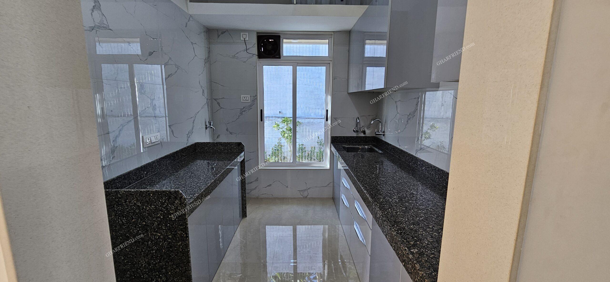 Stylish & Functional Kitchen – The Heart of Your Home Modern modular kitchen with granite countertops, stainless steel sink, ample storage cabinets, and elegant tile finishes in a 1 & 2 BHK apartment at Mira Road