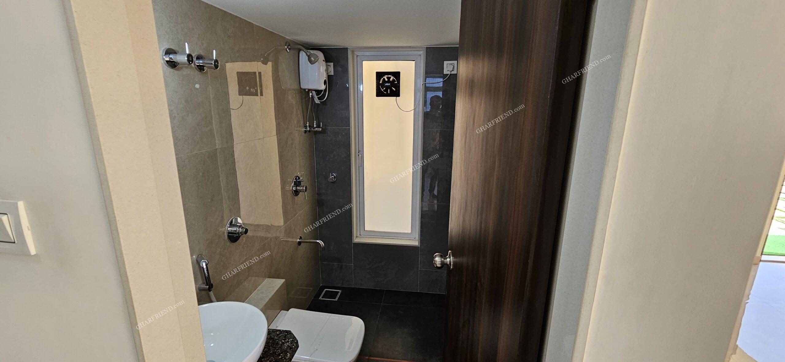 Elegant & Functional Washroom Design Modern and well-designed washroom with premium sanitary fittings, anti-skid flooring, and full-height designer tiles in a 1 & 2 BHK apartment at Mira Road.