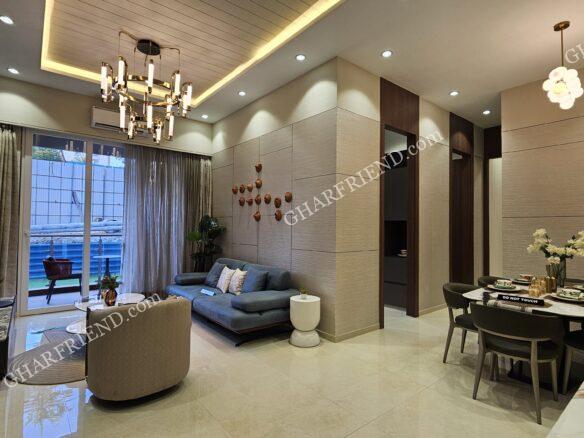 "Spacious and elegantly designed living room in a 3BHK apartment at Malad West." "Modern living room with stylish furniture, warm lighting, and a luxurious ambiance." "Contemporary living space with a sleek design, large windows, and premium interiors." "3BHK apartment living room featuring an open layout, cozy seating, and a refined aesthetic." "Luxury high-rise living room with panoramic views of the Malad West skyline."