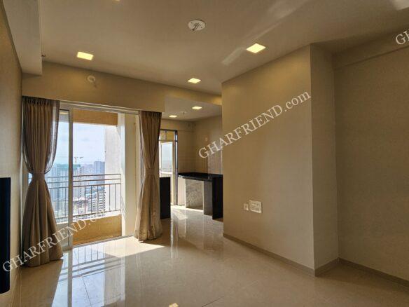 A modern high-rise residential building in Vinay Nagar, Mira Road, surrounded by lush green spaces, offering affordable 1BHK ready-to-move-in apartments with premium amenities.