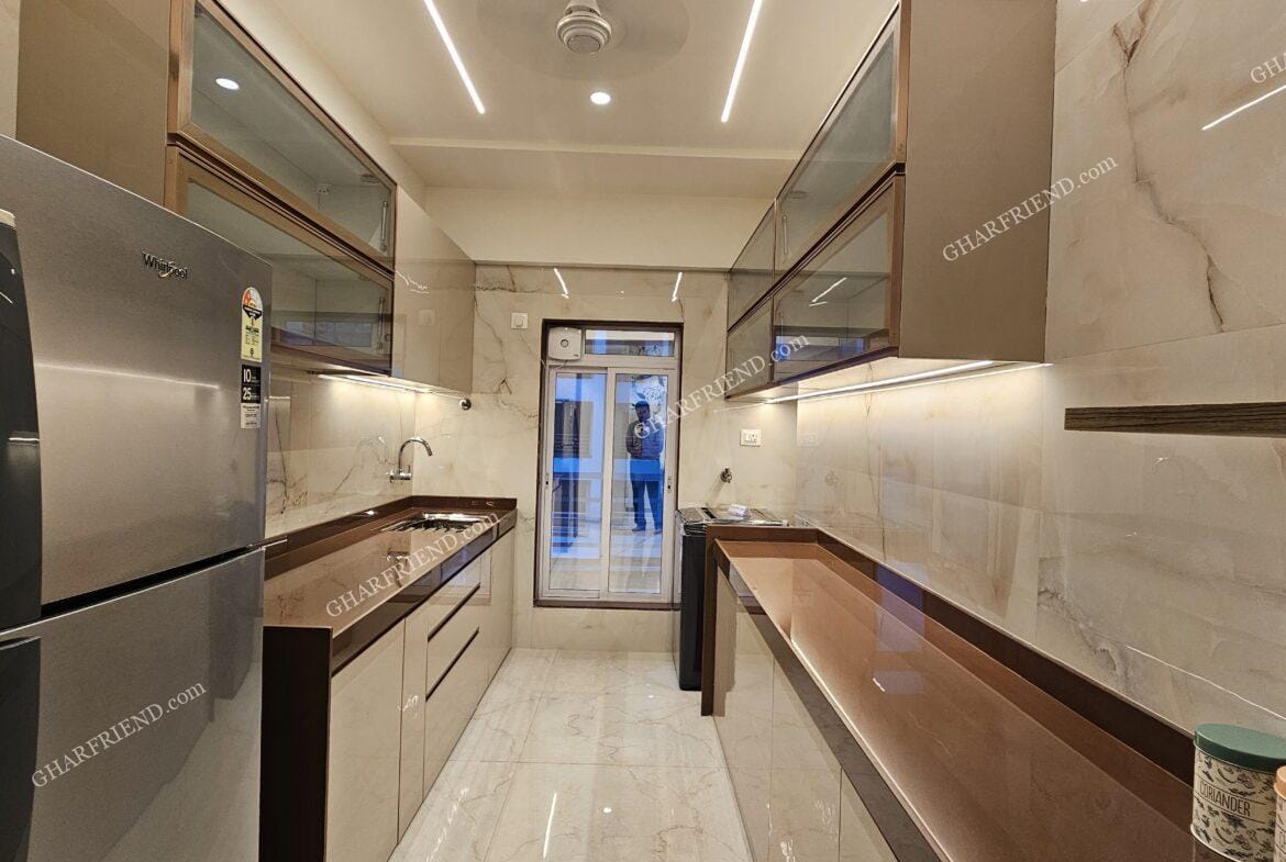 A modern and well-equipped kitchen in a 1 & 2 BHK apartment at Mira Road, featuring sleek cabinets, ample storage, and a functional layout for an efficient cooking experience.