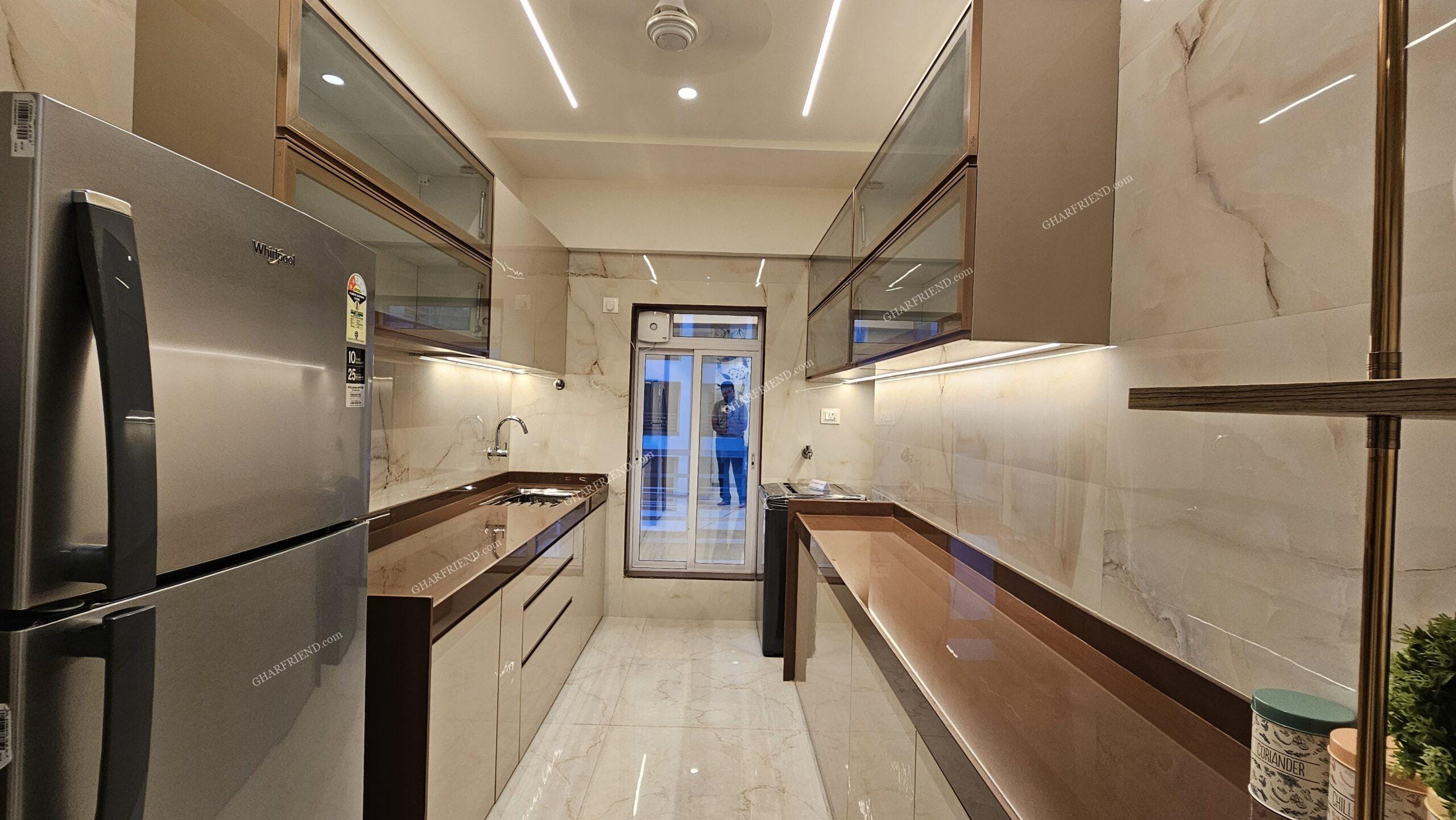 A modern and well-equipped kitchen in a 1 & 2 BHK apartment at Mira Road, featuring sleek cabinets, ample storage, and a functional layout for an efficient cooking experience.