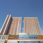 Modern high-rise residential tower in Vinay Nagar, Mira Road, featuring sleek architecture, landscaped gardens, and luxury amenities.